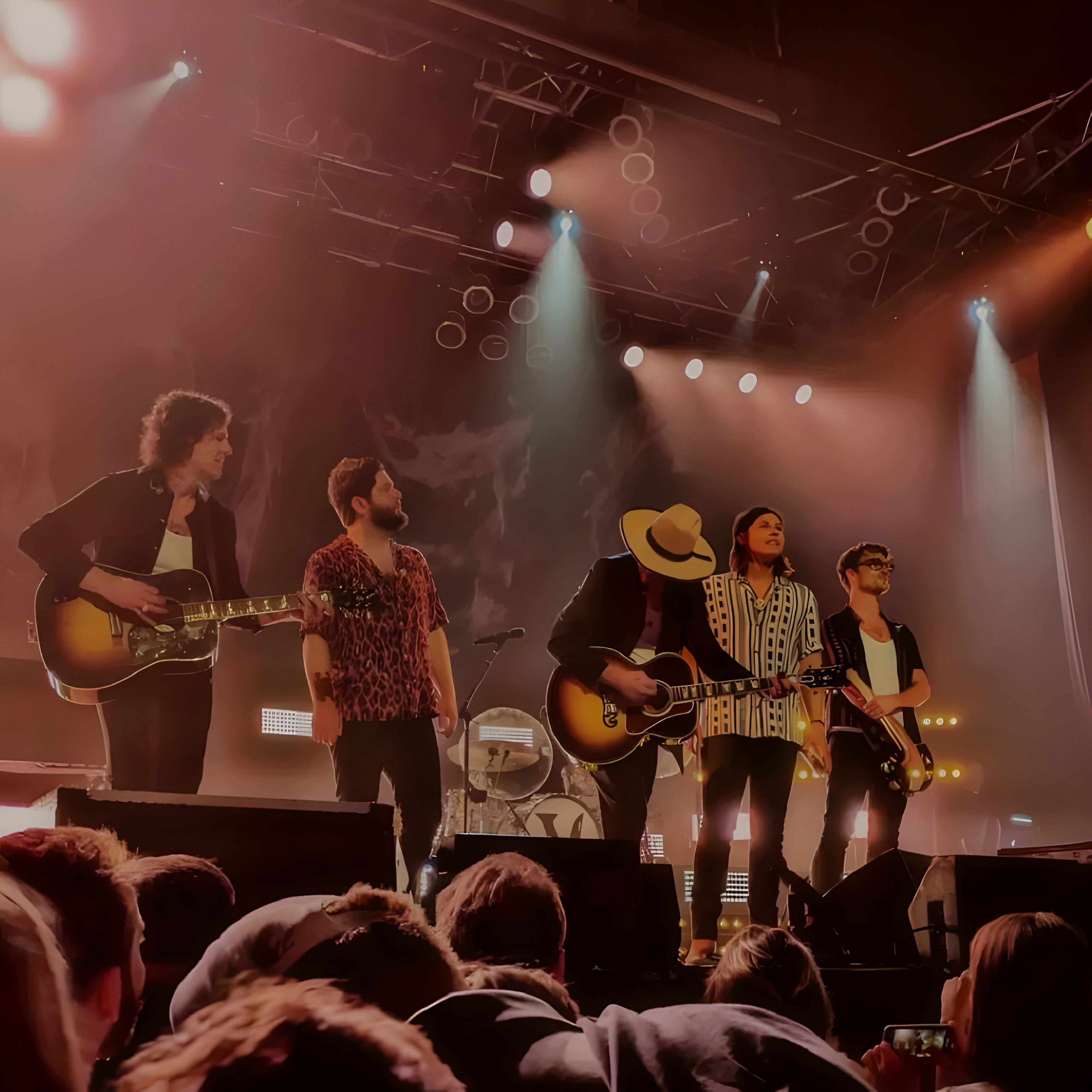 Five-piece band on stage in front of the crowd